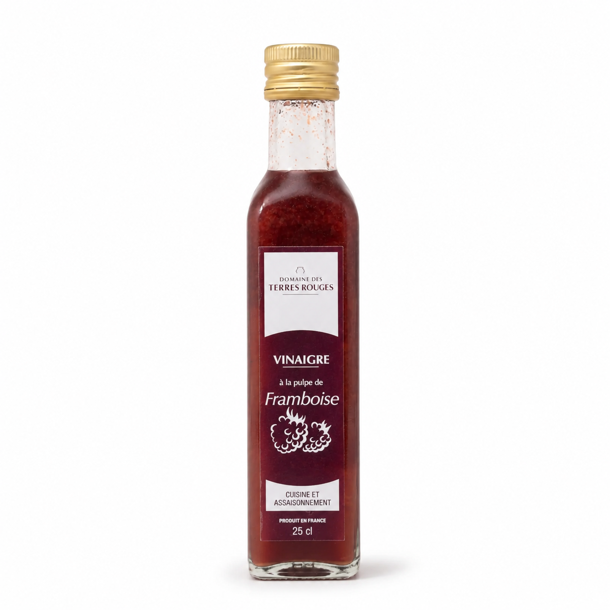 Bottle of framboise vinegar with a gold cap on a white background