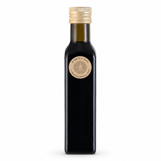Black bottle with gold cap and label on a white background