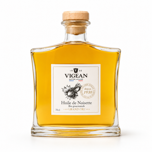 Bottle of Vigean hazelnut oil with a wooden cap on a white background