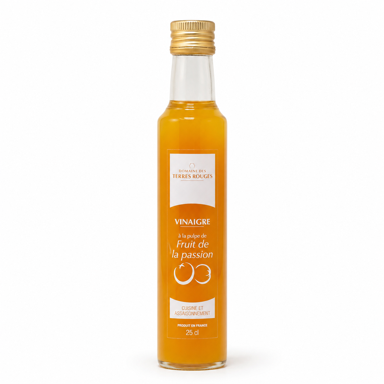 Bottle of fruit vinegar with a gold cap on a white background