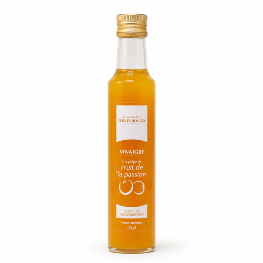 Bottle of fruit vinegar with a gold cap on a white background