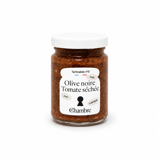 Jar of olive tapenade with a white label on a white background